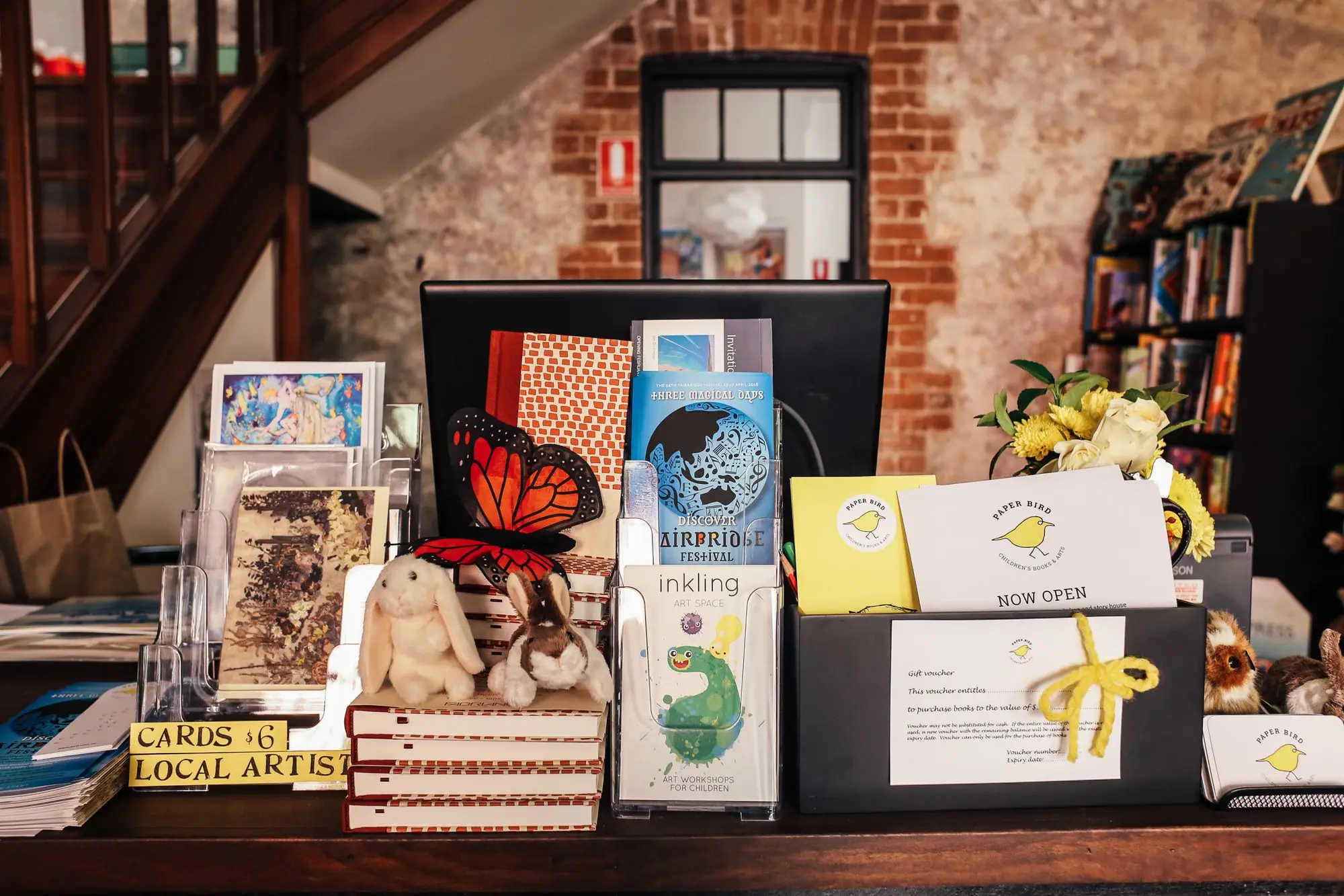 Gift voucher sign, greeting cards and locally made gifts on an independent shop counter ahead of the Christmas rush