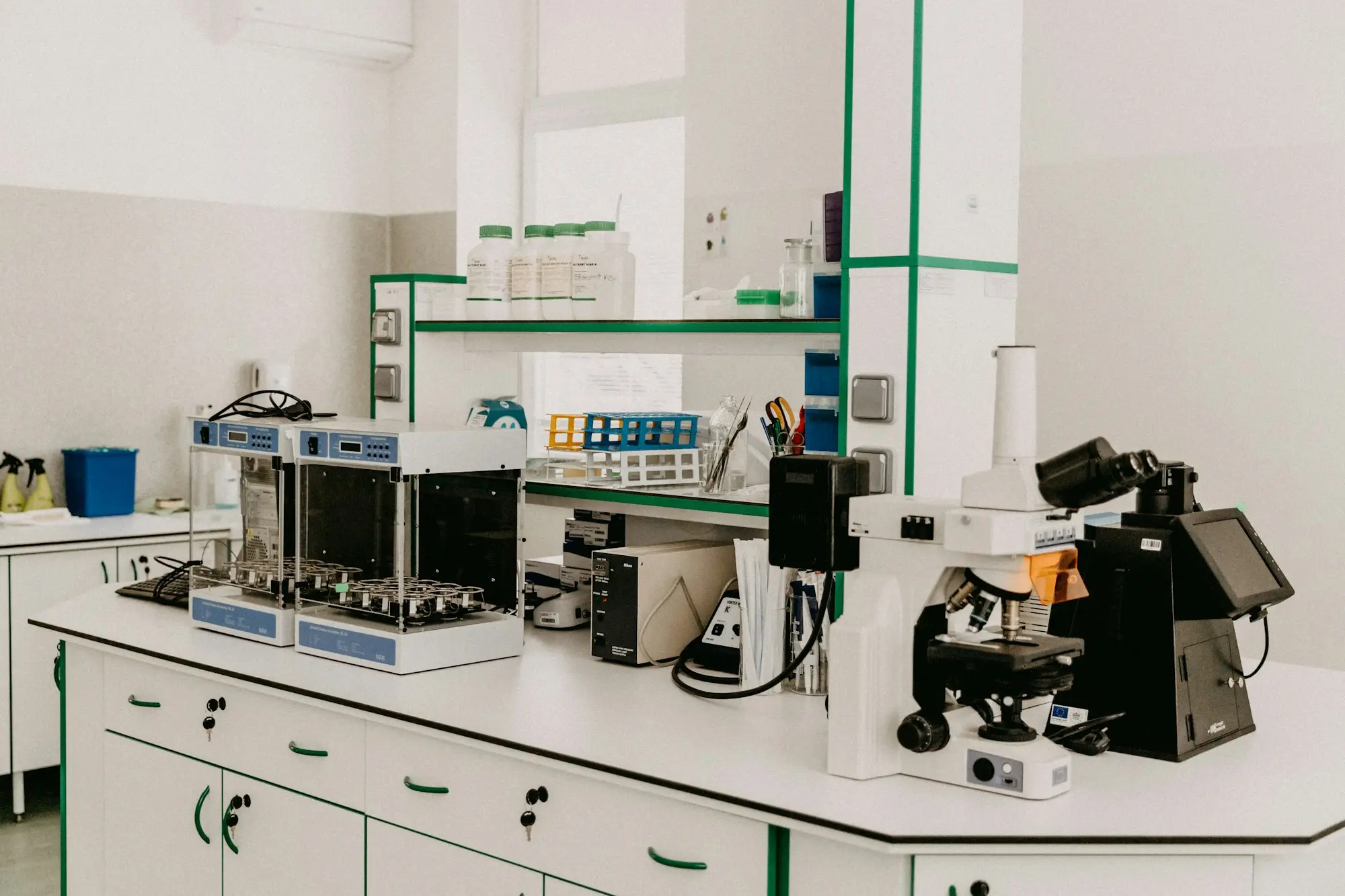 R&D lab bench with a microscope, sample bottles and testing equipment where a small business develops a new product